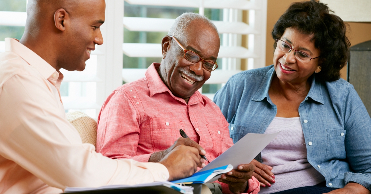 financial advisor talking to senior couple at home