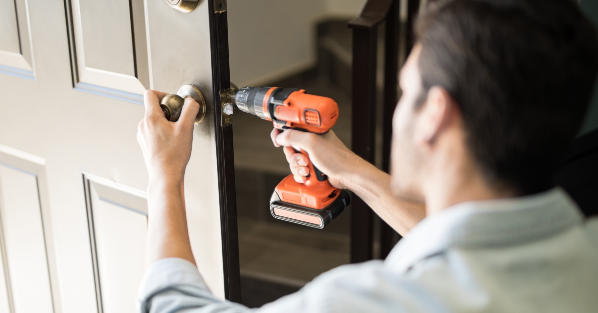 handyman fixing door knob