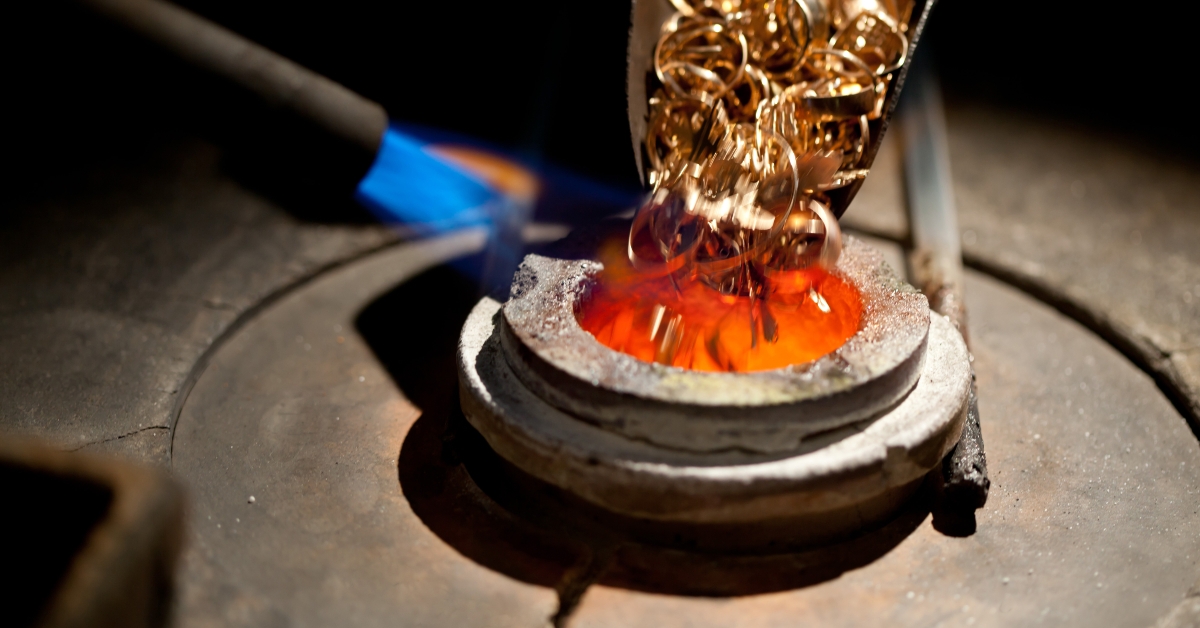 pieces of gold loaded into furnace for melting
