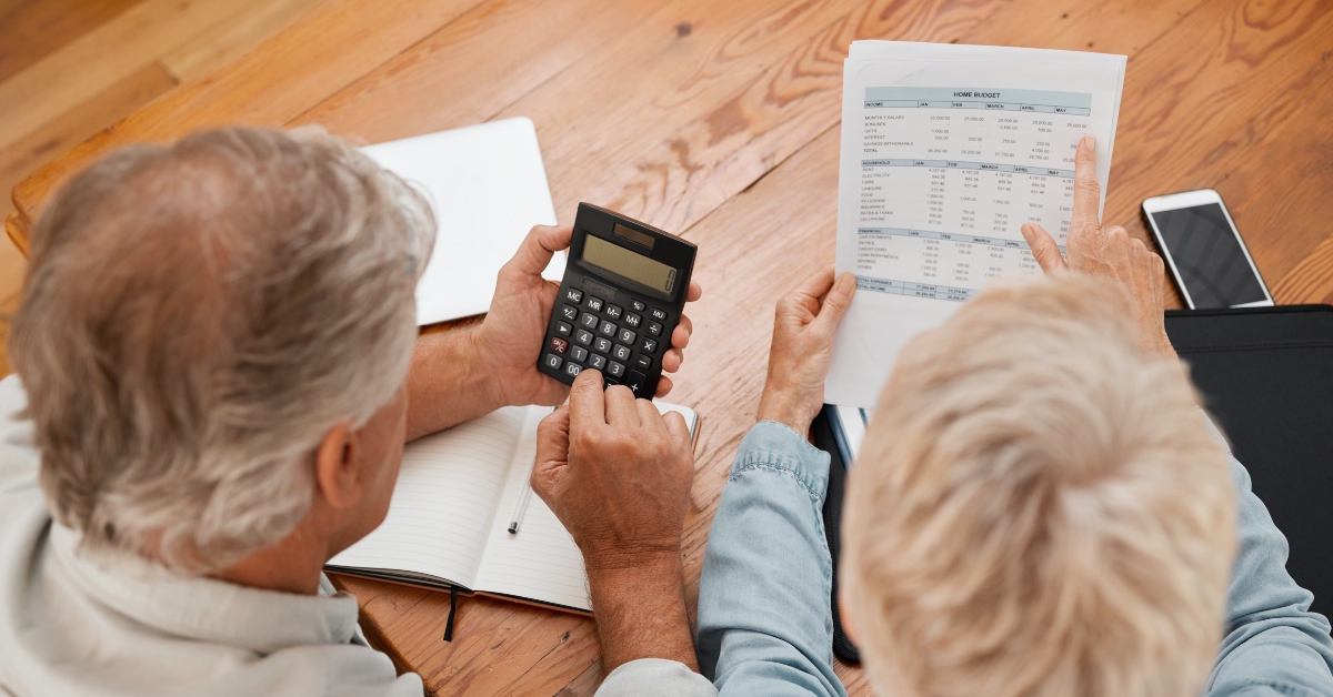 senior couple with calculator planning financial investments