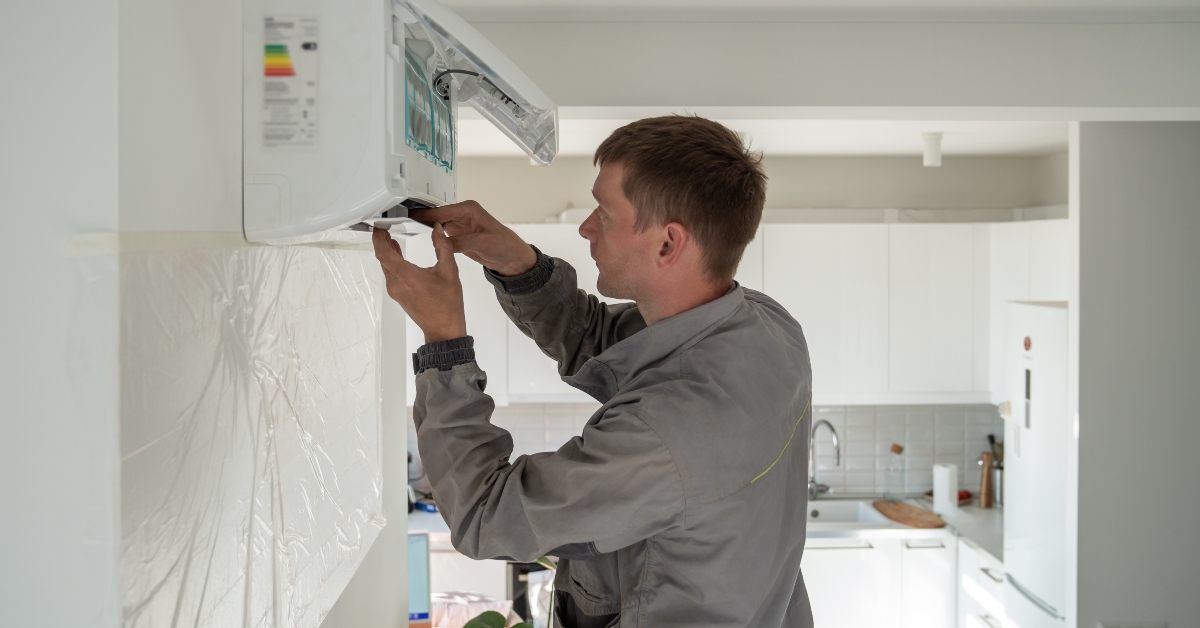 technician worker fixing repairing apartment air conditioner
