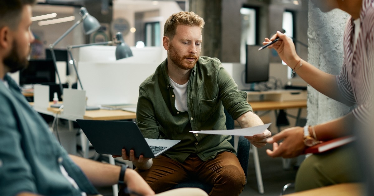 Confident financial advisor pointing at  laptop
