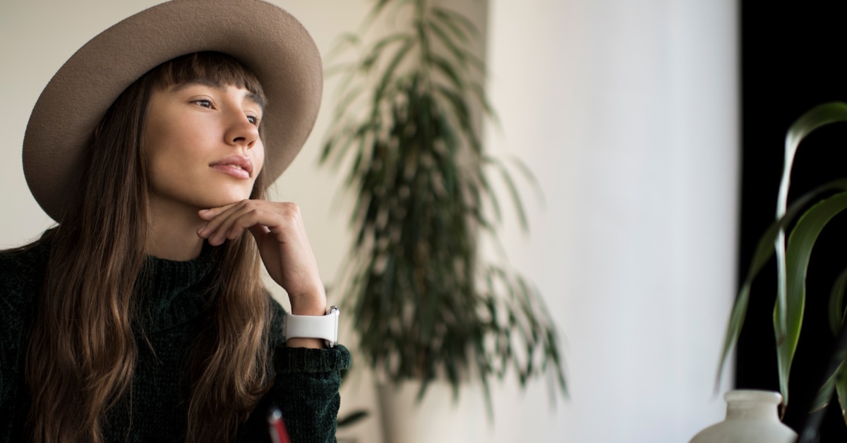 A young female writer is deep in thought, searching for a new idea for her next novel.