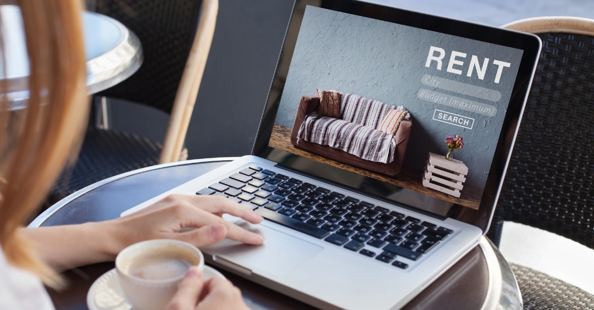  A woman is browsing rental apartments and flats on an internet website while sitting in a cafe.