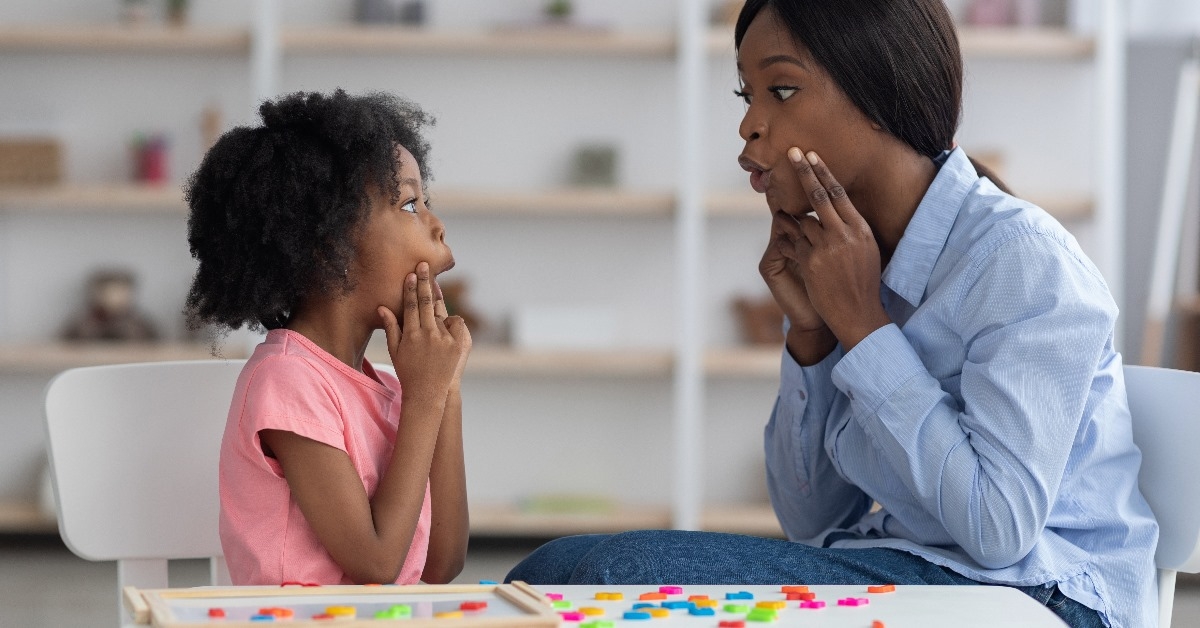speech therapist putting her hands on her cheeks
