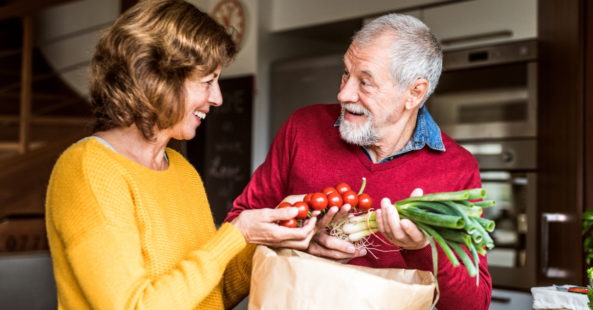 senior couple preparing food in the kitchen