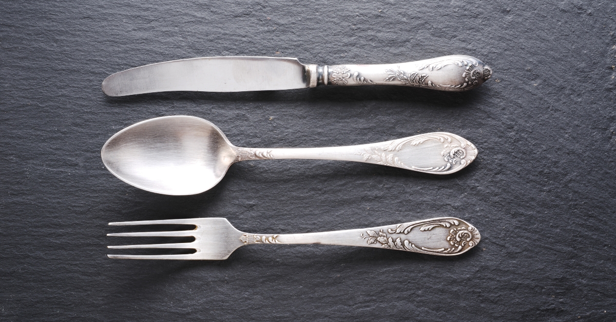 silver cutlery on a dark grey background
