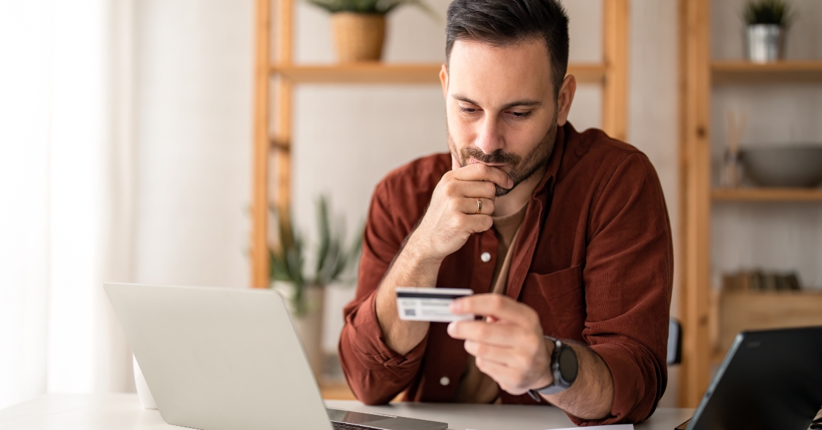 businessman looking at credit card