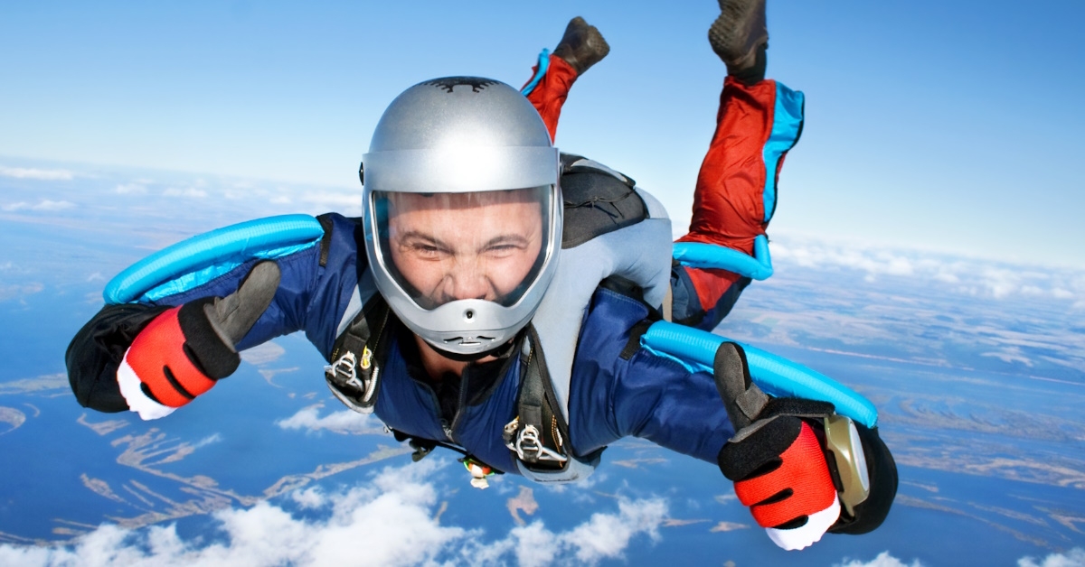 sky diver doing thumbs up in air
