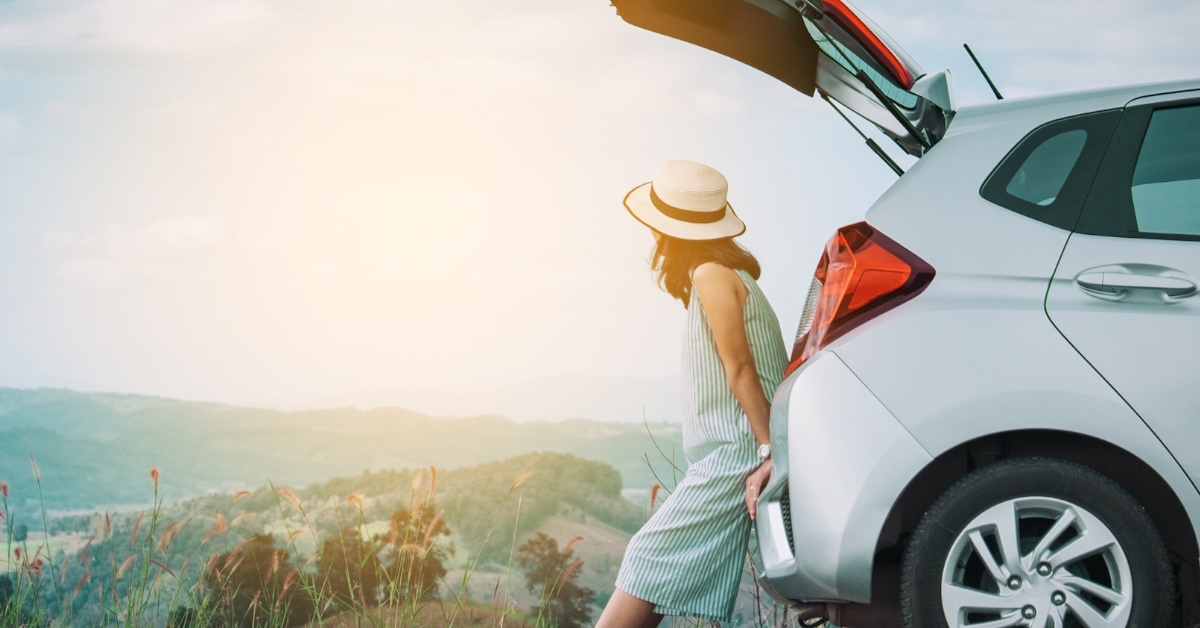 woman sitting in car trunk 