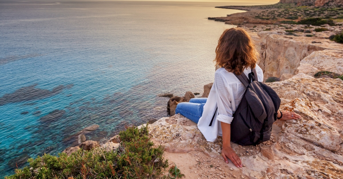 woman watching sunset from cliff