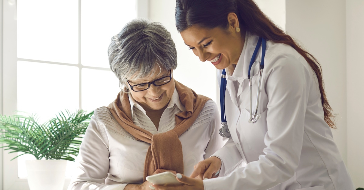female-doctor-showing-smartphone-to-lady