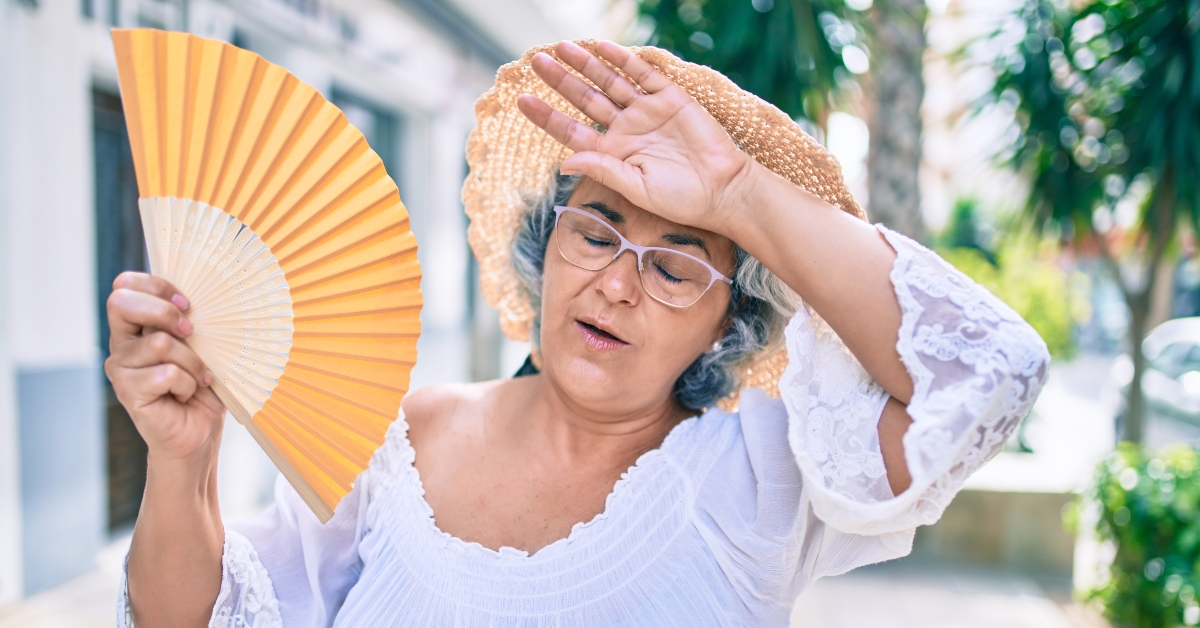 middle age woman using handfan