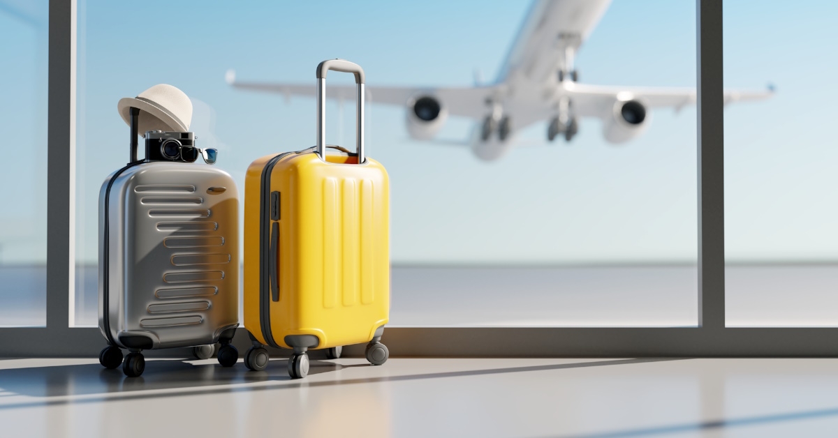 suitcases besides window in airport lounge