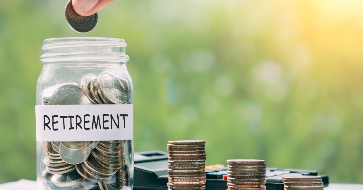 hand putting money for retirement