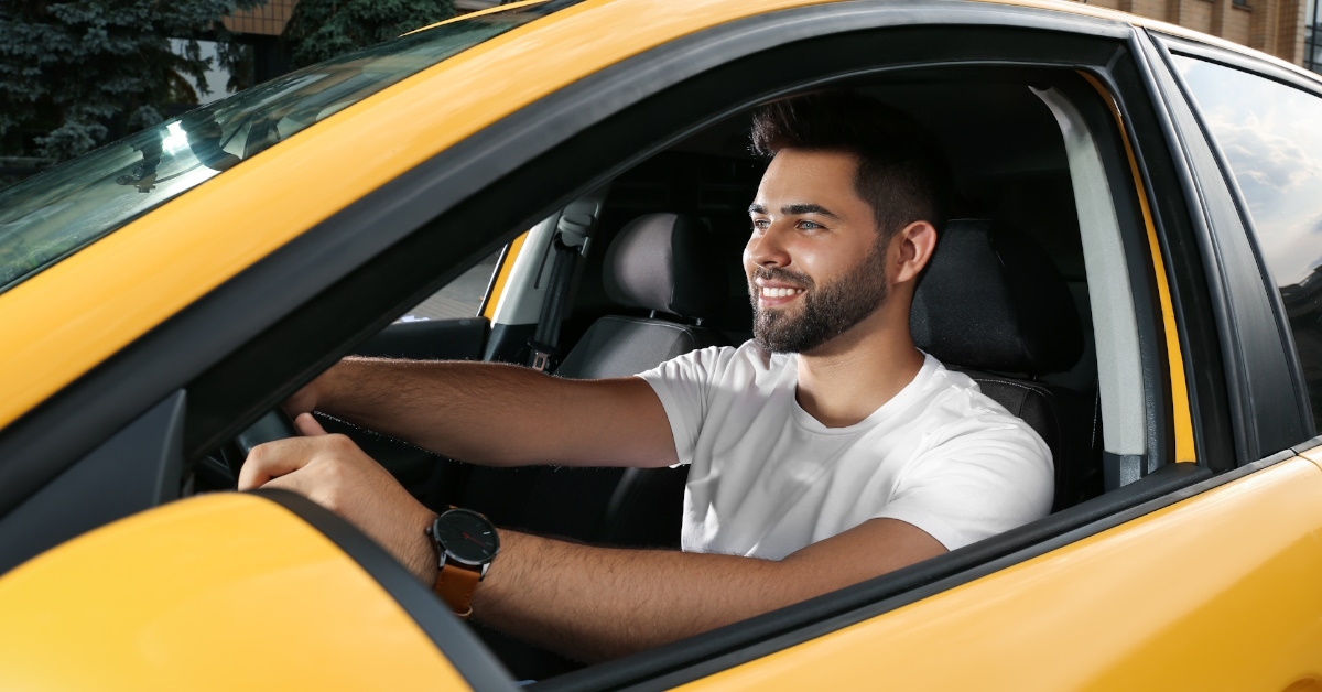 young man driving his taxi.