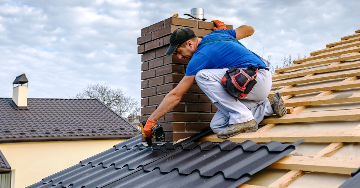 man is working to cover the roof.