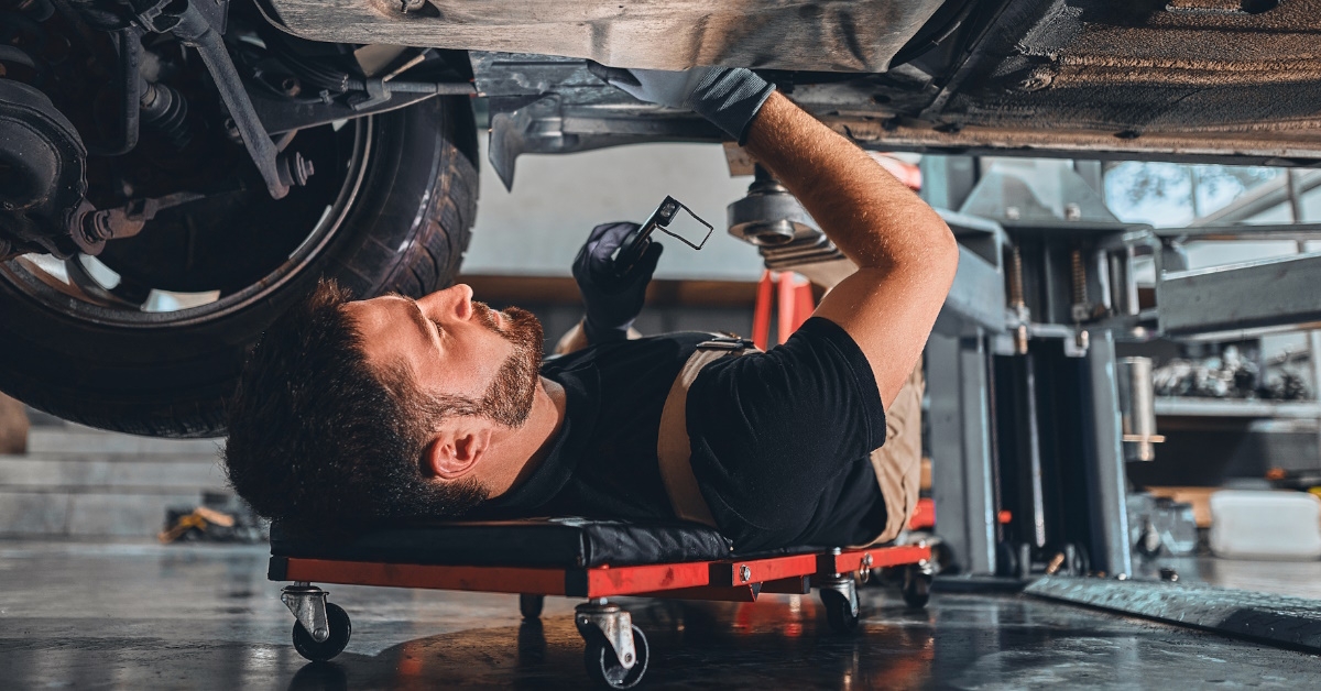 mechanic using wrench to perform repairs. 