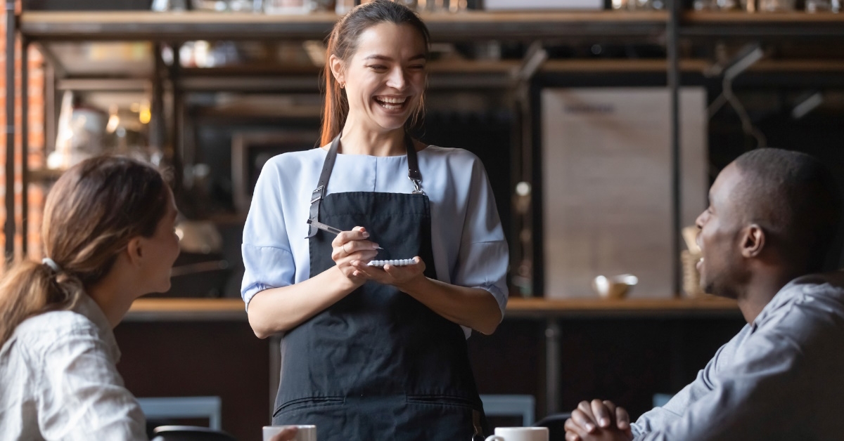 waitress accepting orders from customers.