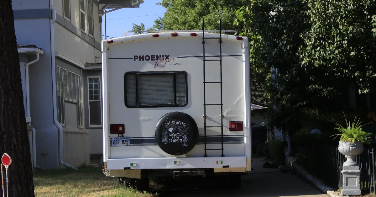 Camping RV parked in a driveway.