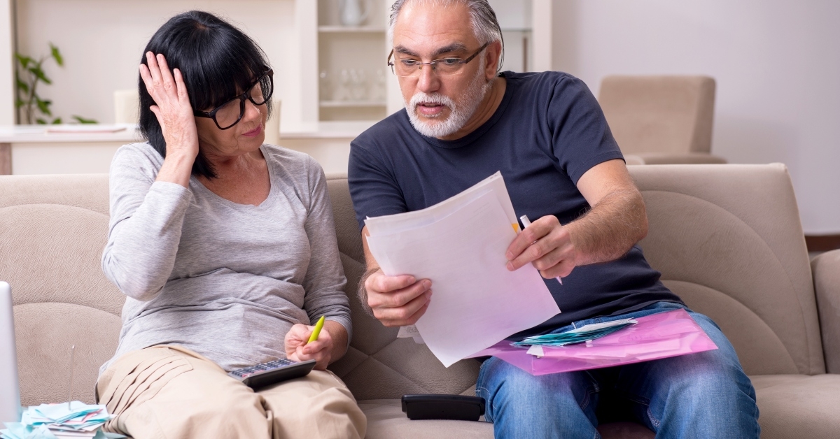 old couple discussing paperwork
