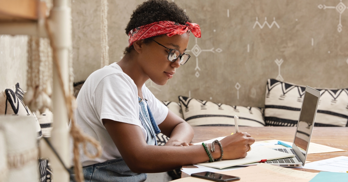 woman writes down on paper