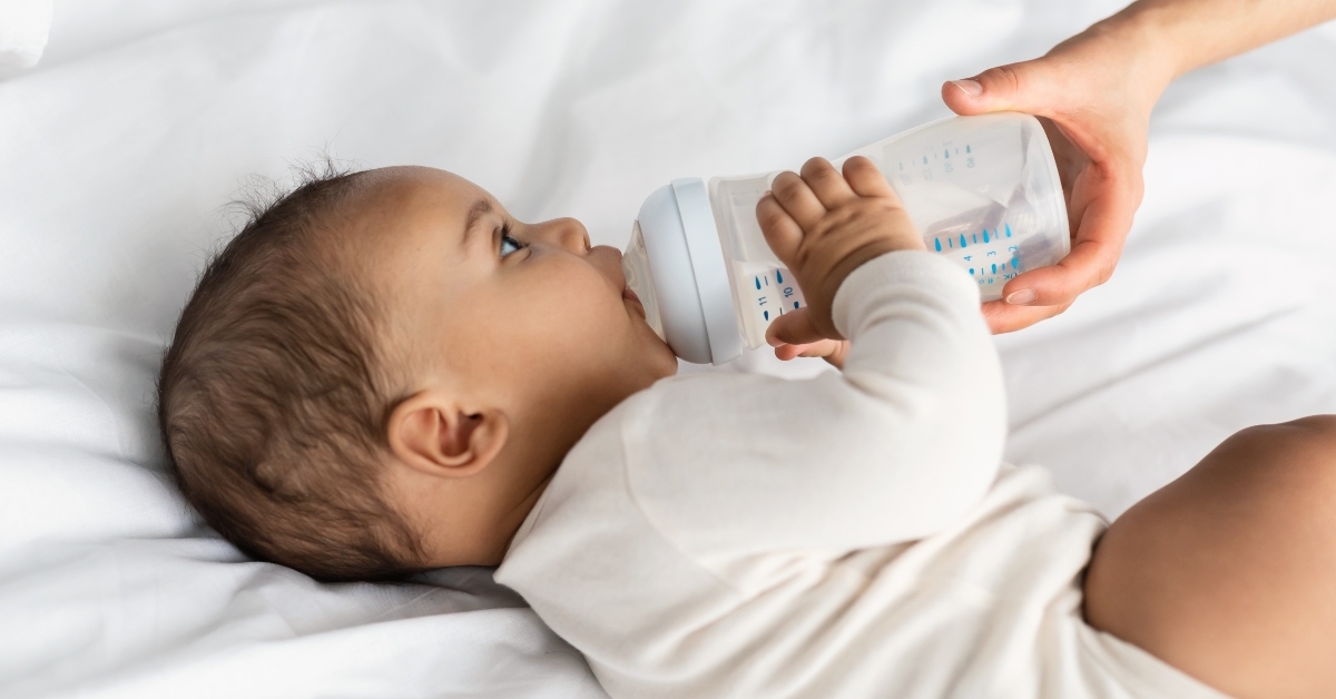  child drinking from baby bottle