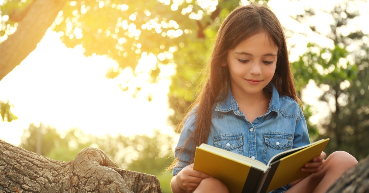 cute little girl reading book