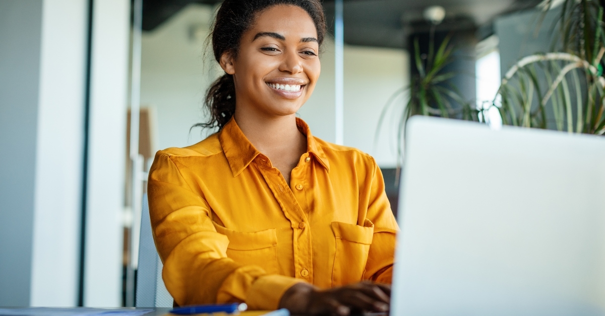 Smiling woman typing on a computer