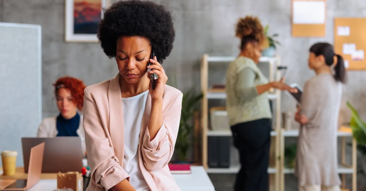  woman looking down while conversing over phone.