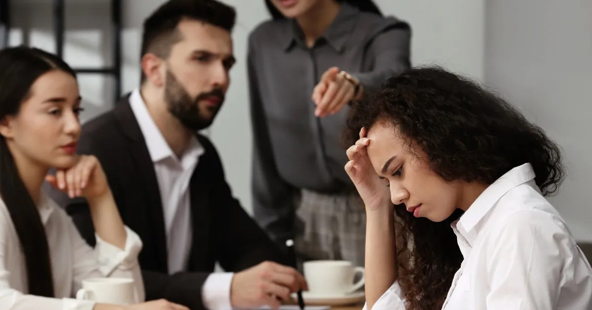 woman facing emotional abuse from senior peers.