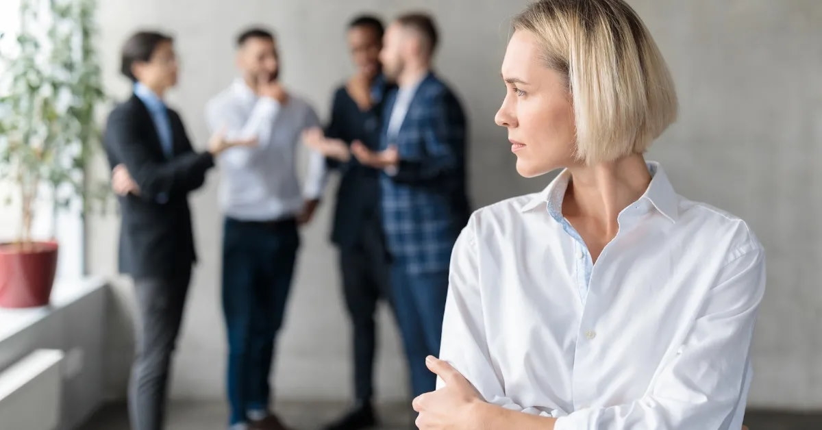 coworkers whispering about female colleague. 