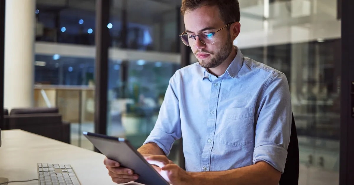 man is engaged in work on a tablet device.