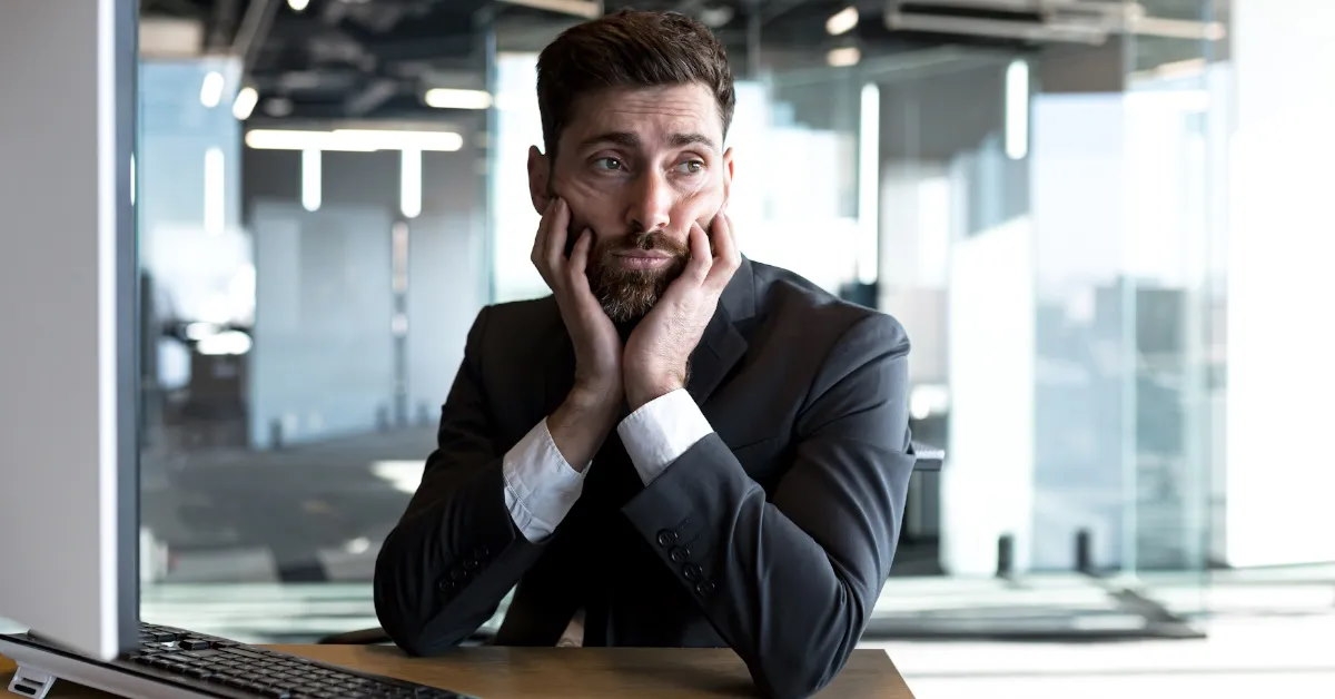 tired businessman is deep in thought while working.