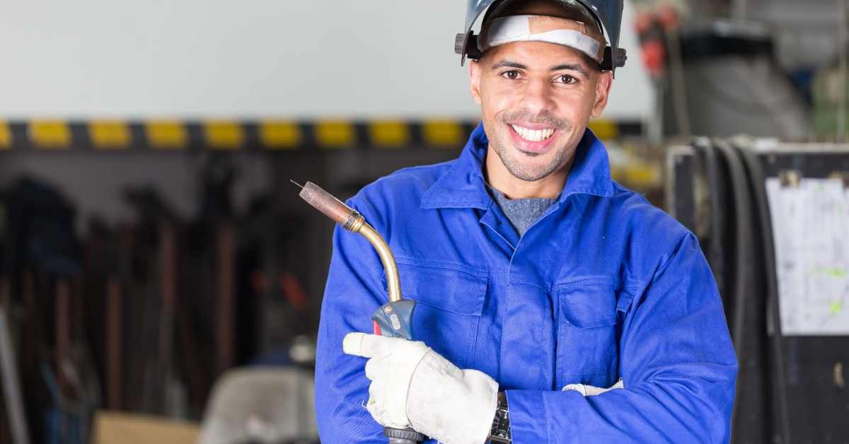 welder posing with welding machine