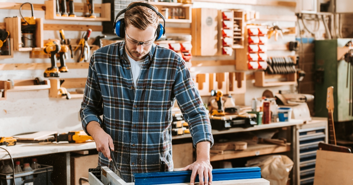 woodworker in protective headphones