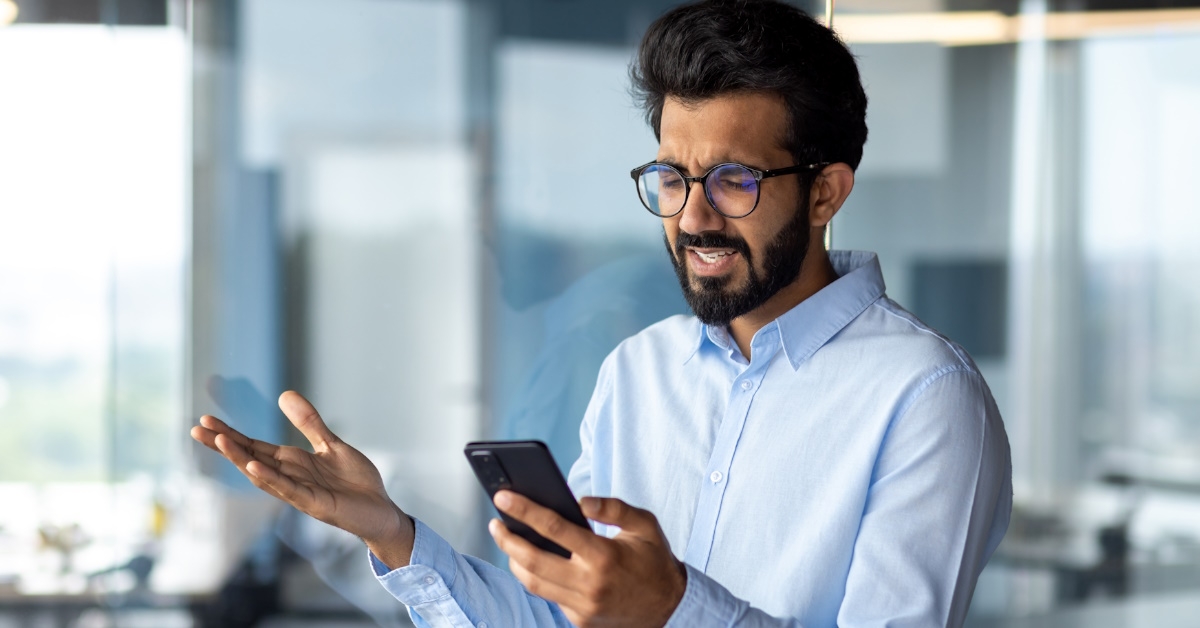 Man looking frustrated at phone