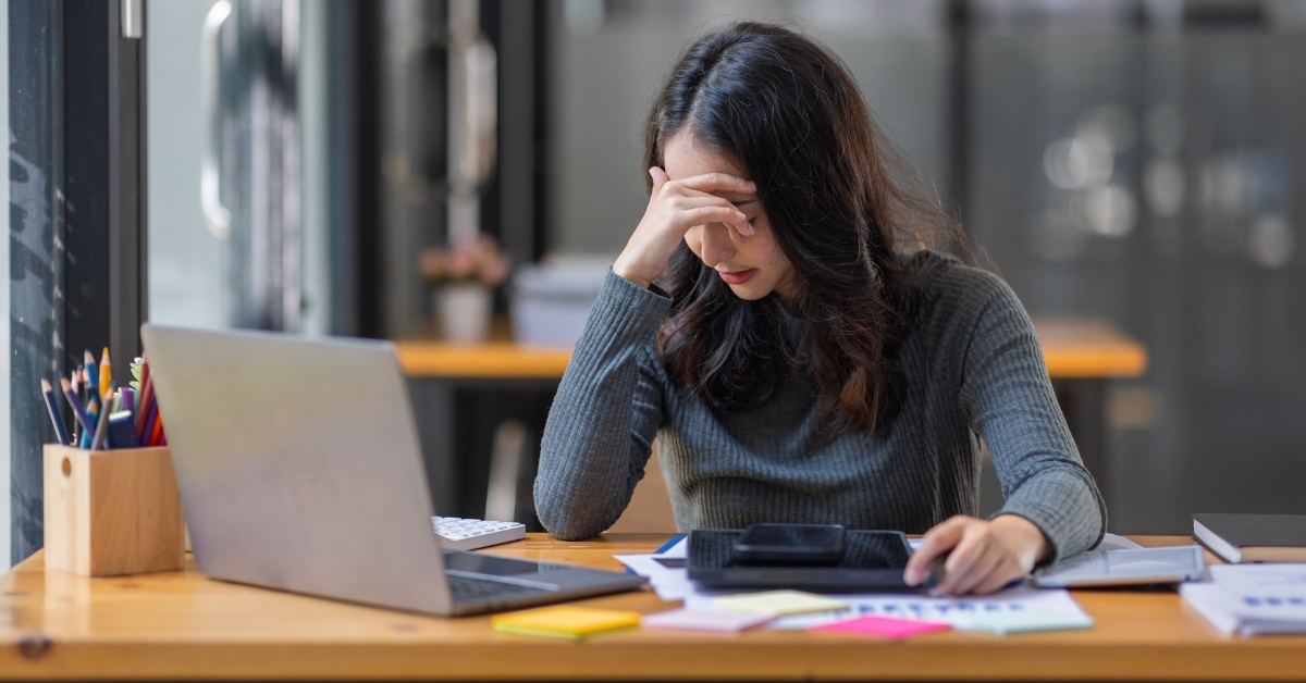 Woman stressed at laptop