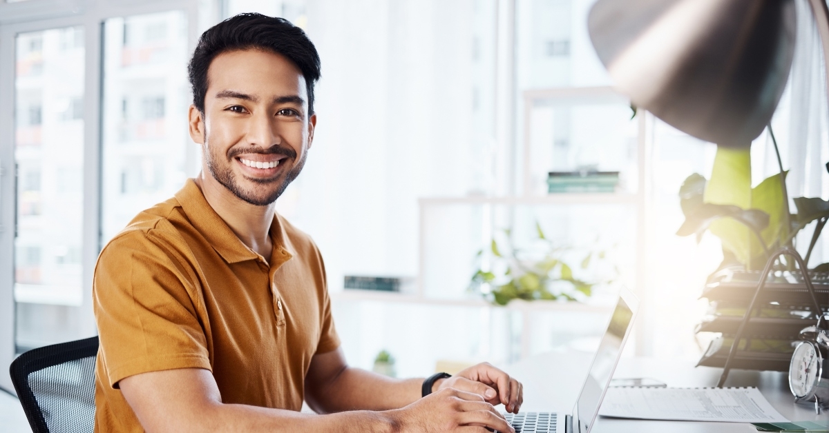 A happy person at a laptop
