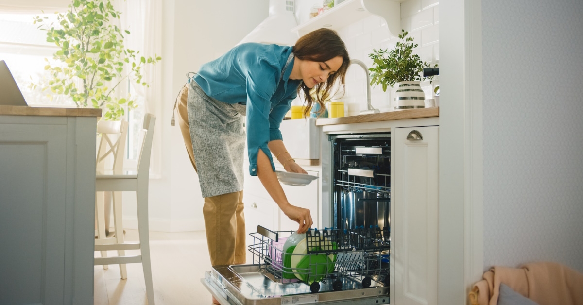 Woman loading dishes in dishwasher