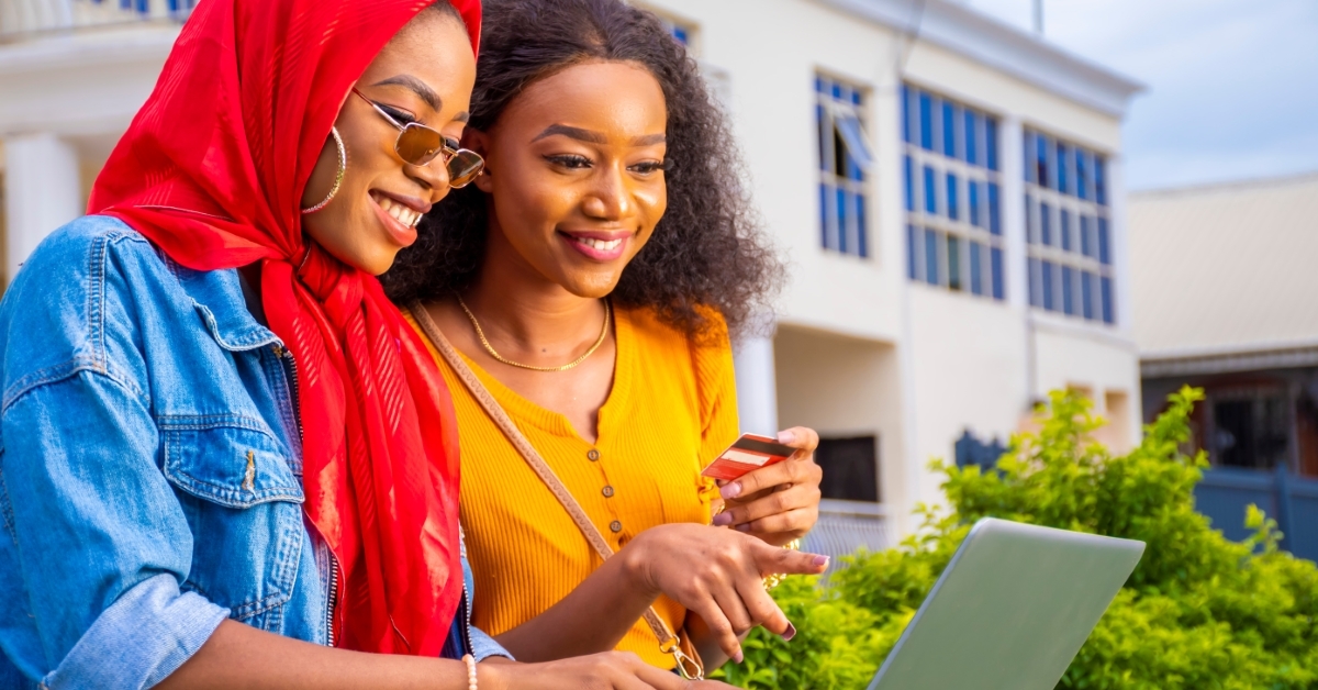 Two young women learning about credit cards