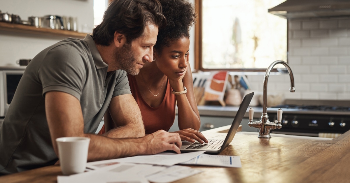Couple using laptop for reviewing budget
