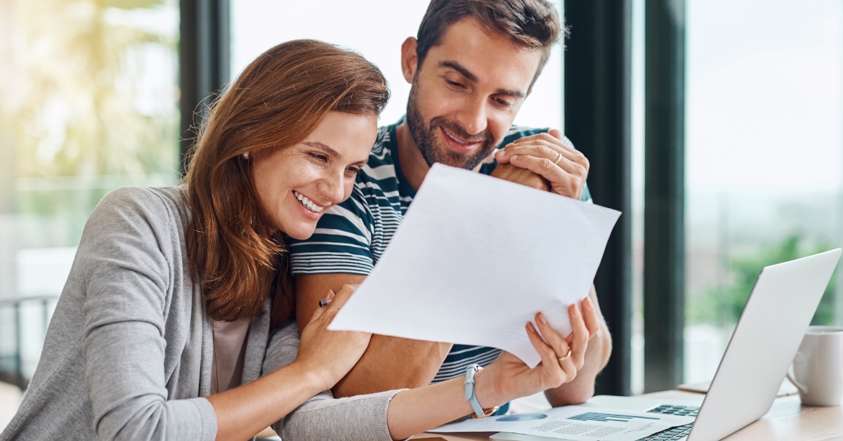 Happy couple looking at paperwork