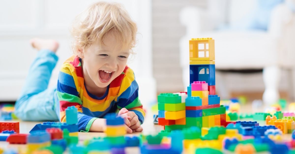 Child playing with blocks on floor