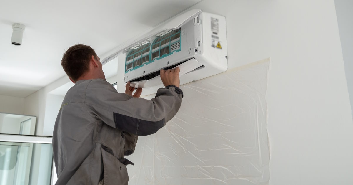 male worker installing air conditioner