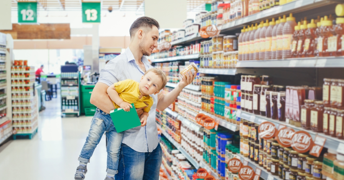 dad carrying baby son under arm