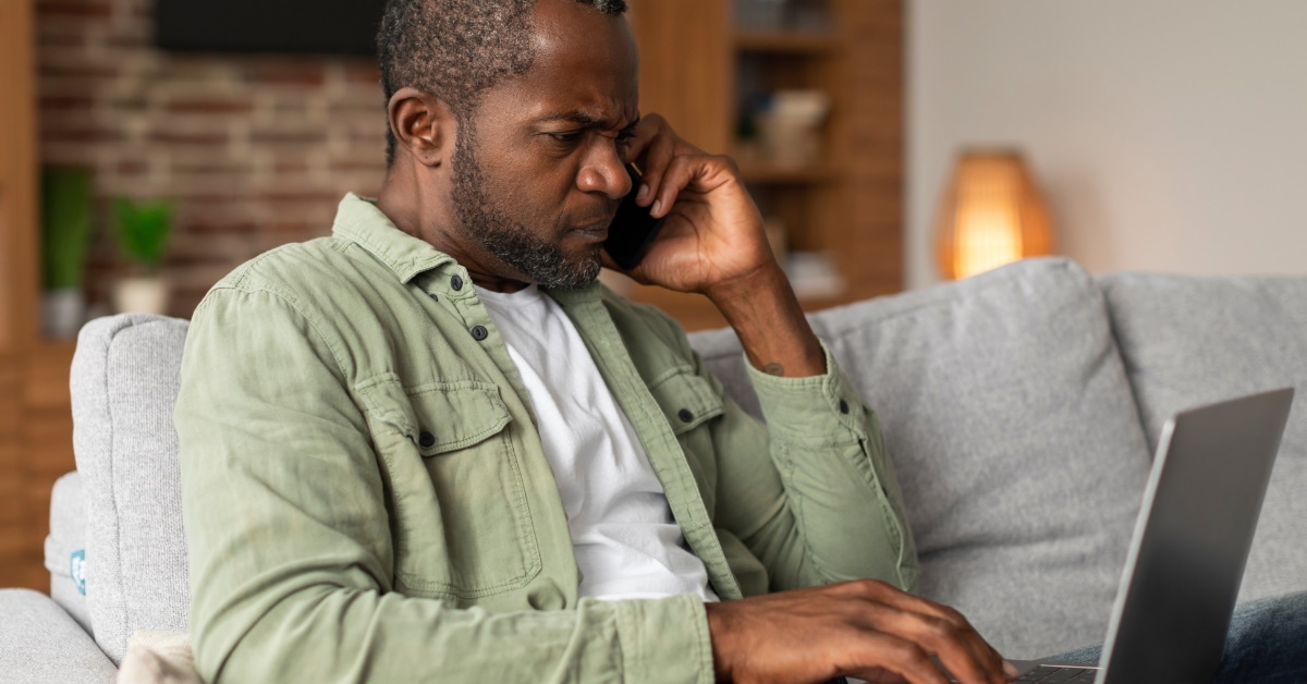 Man on call on laptop