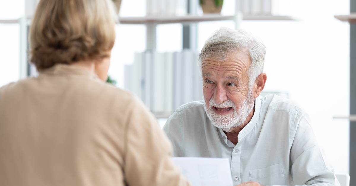 Senior businessman talking to young employee