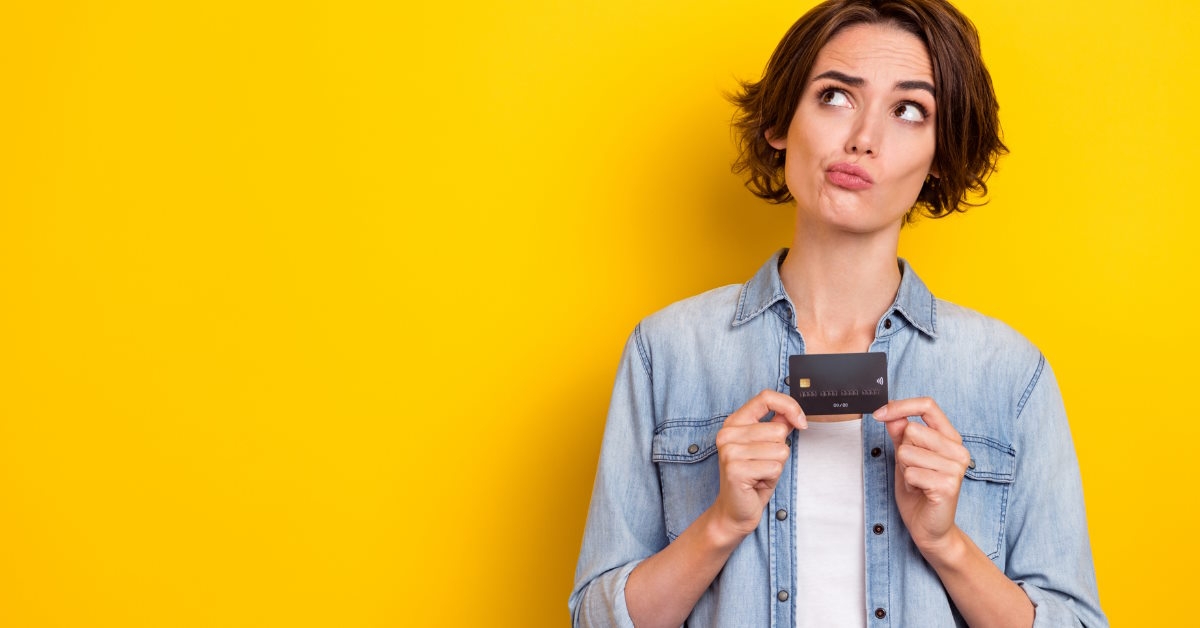 woman acting confused while holding card