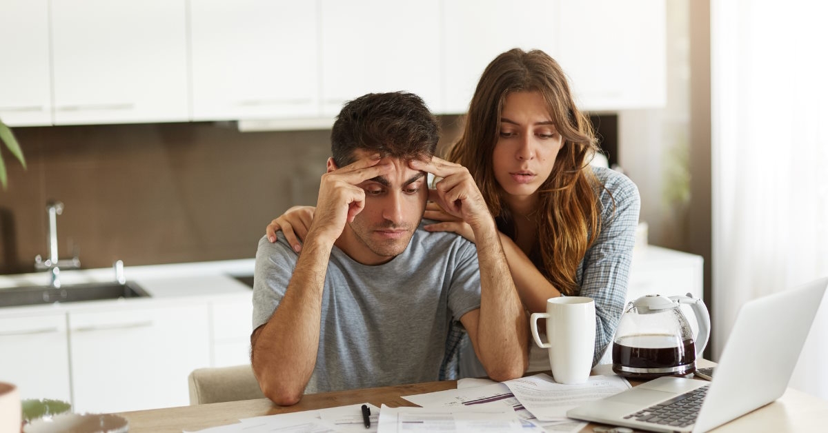 couple stressing at utility bills 
